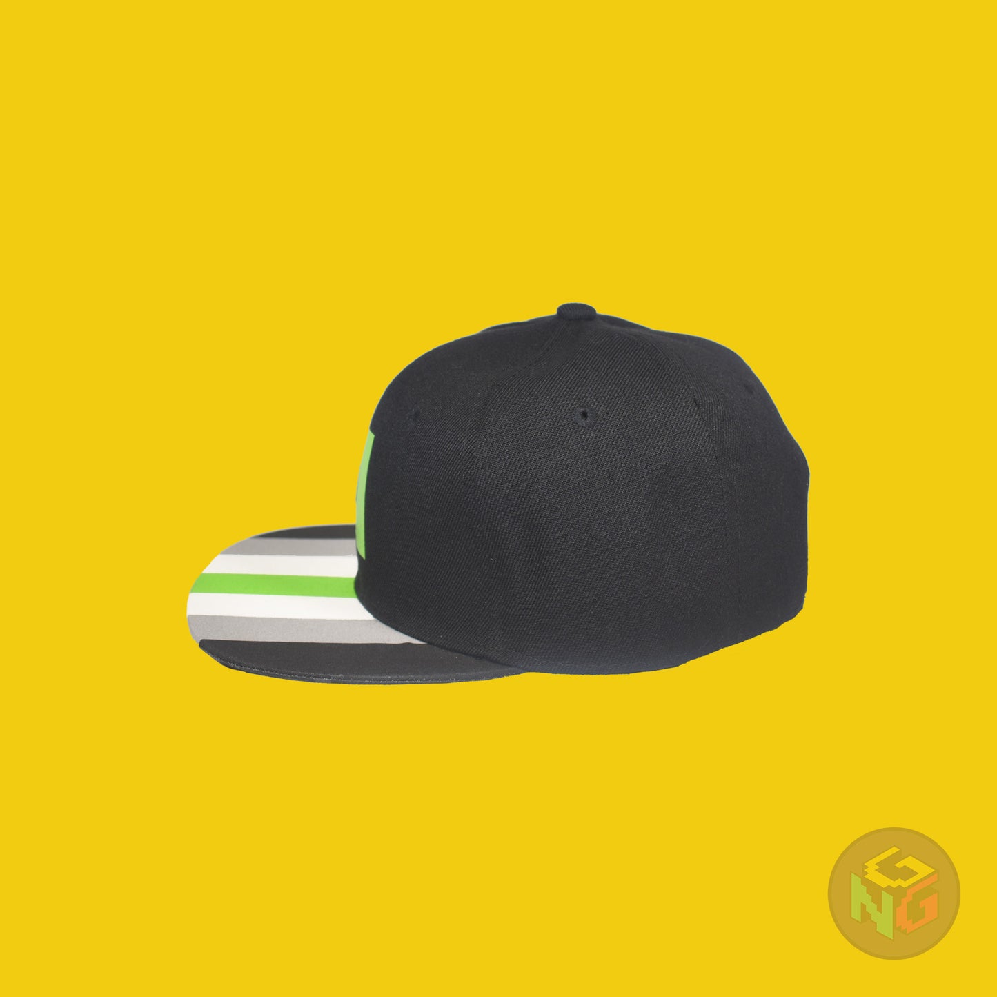 Black flat bill snapback hat. The brim has the agender pride flag on both sides and the front of the hat has a green letter “A”. Left side view