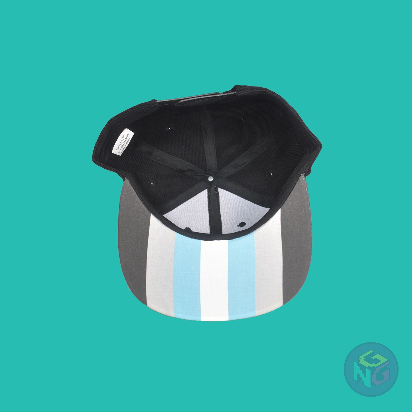 Black flat bill snapback hat. The brim has the demiboy pride flag on both sides and the front of the hat has the word “DEMI” in dark grey, light grey, blue, and white. Underside view