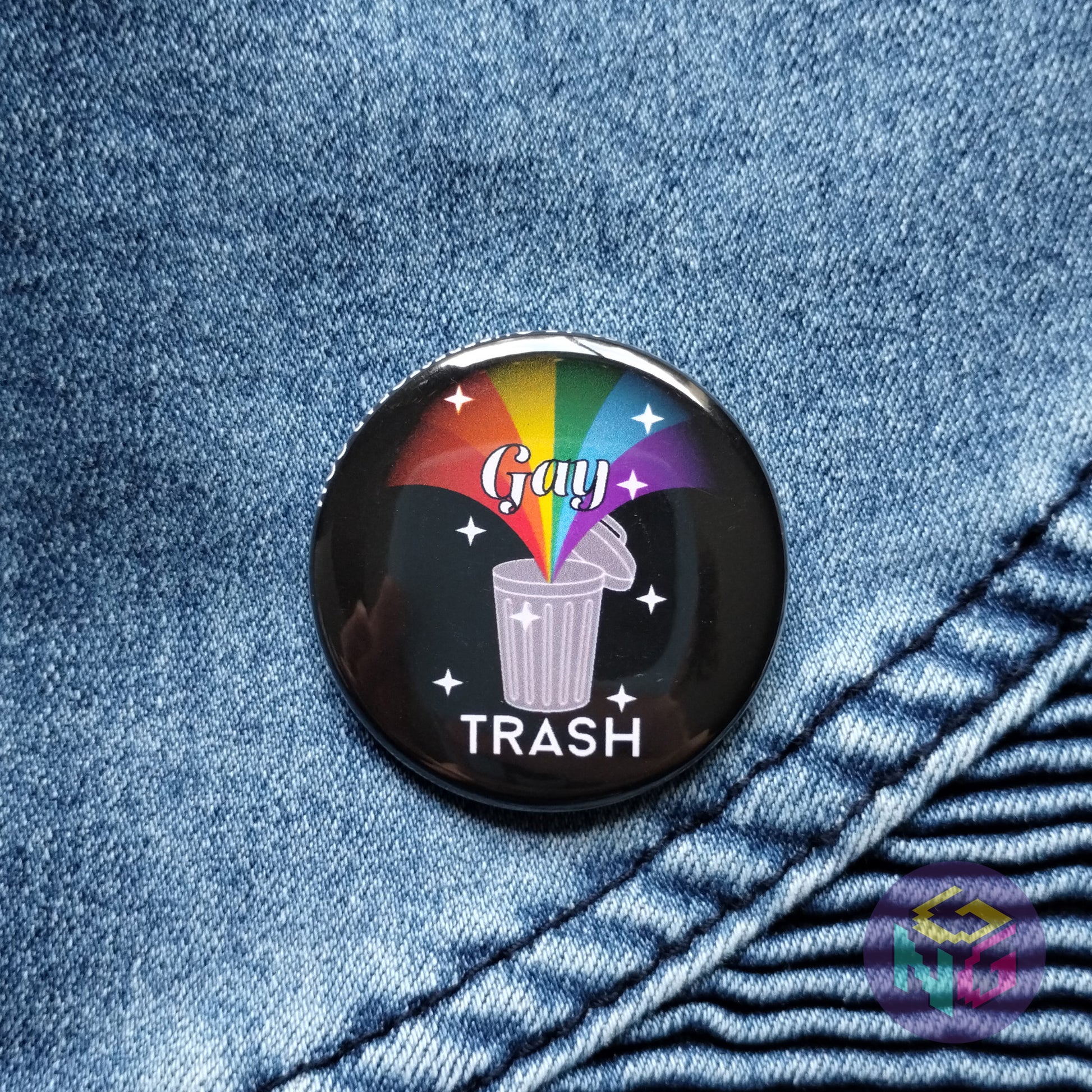 black gay trash pin on denim background