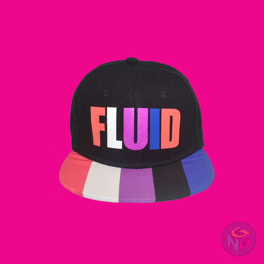 Black flat bill snapback hat. The brim has the genderfluid pride flag on both sides and the front of the hat has the word “FLUID” in peach, white, magenta, and royal blue letters. Front view