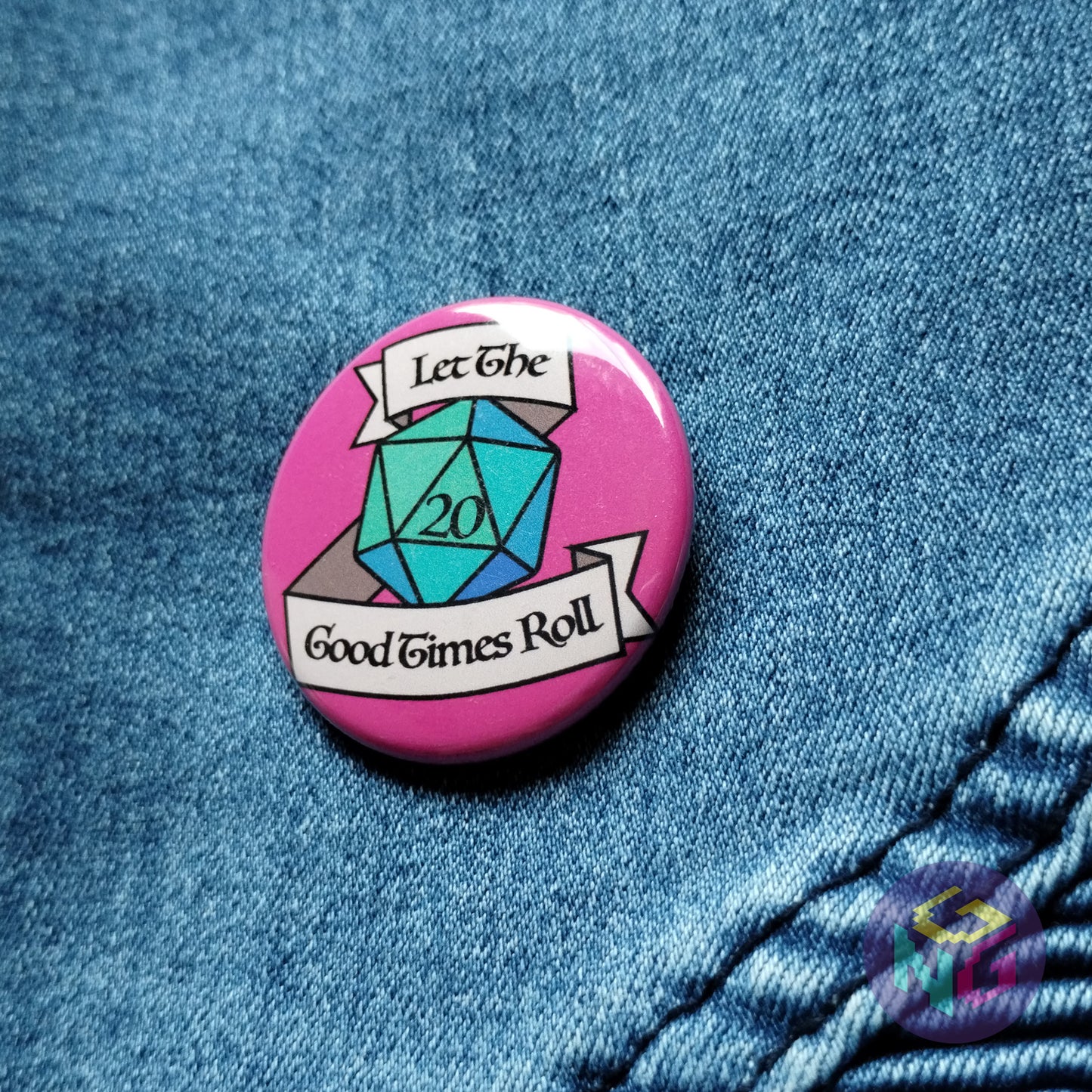 let the good times roll button on front of denim background