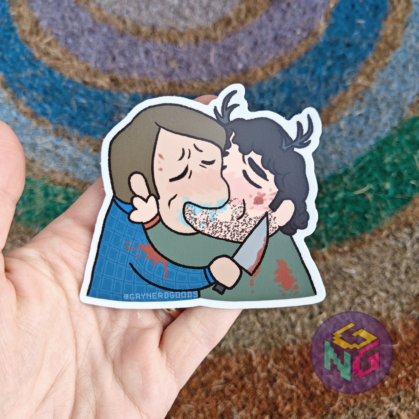 will graham and hannibal kissing waterproof sticker in front of neutral rainbow background