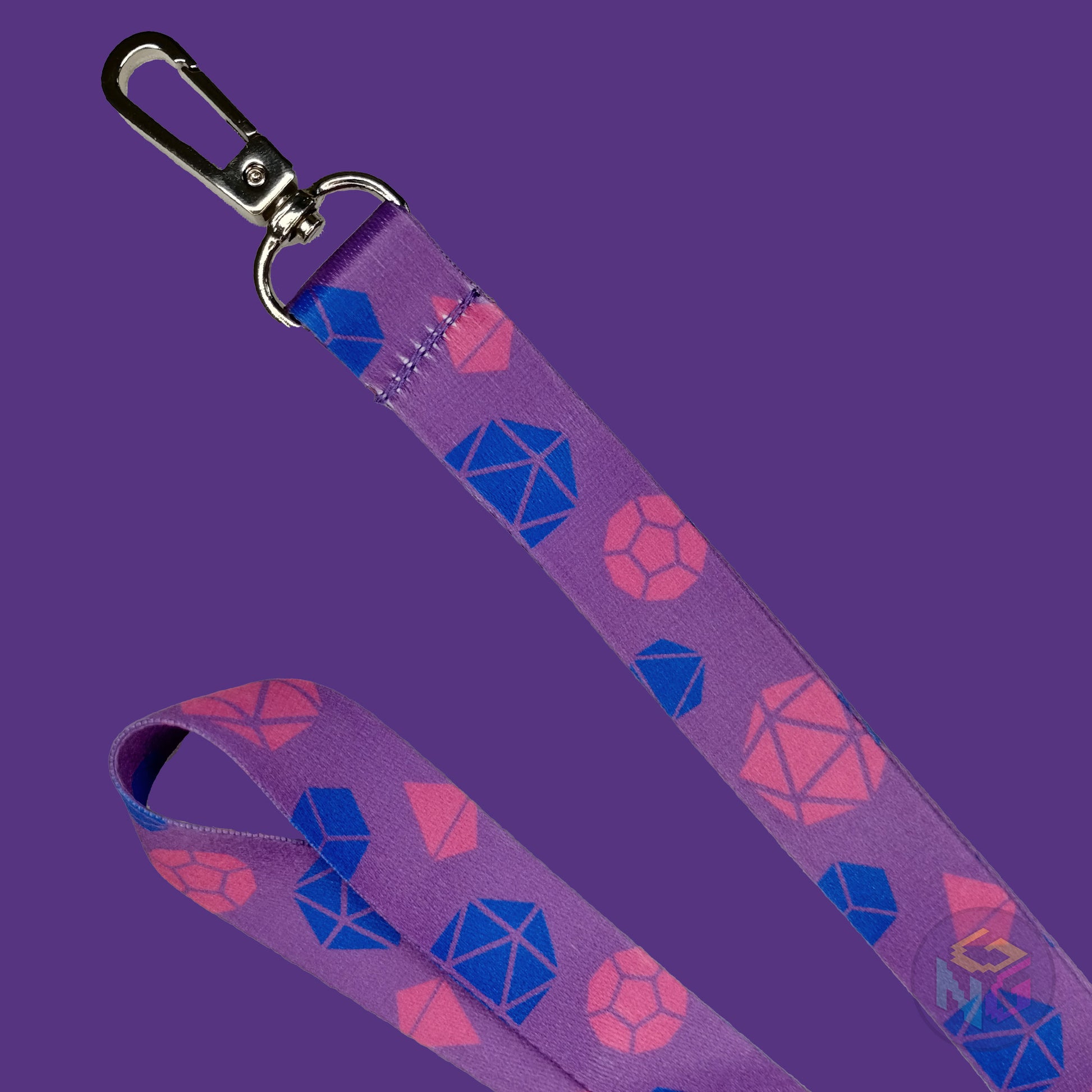 close up detail of the bisexual dungeons and dragons lanyard showing the lobster clasp, blue d20s, pink d4s, and other dice
