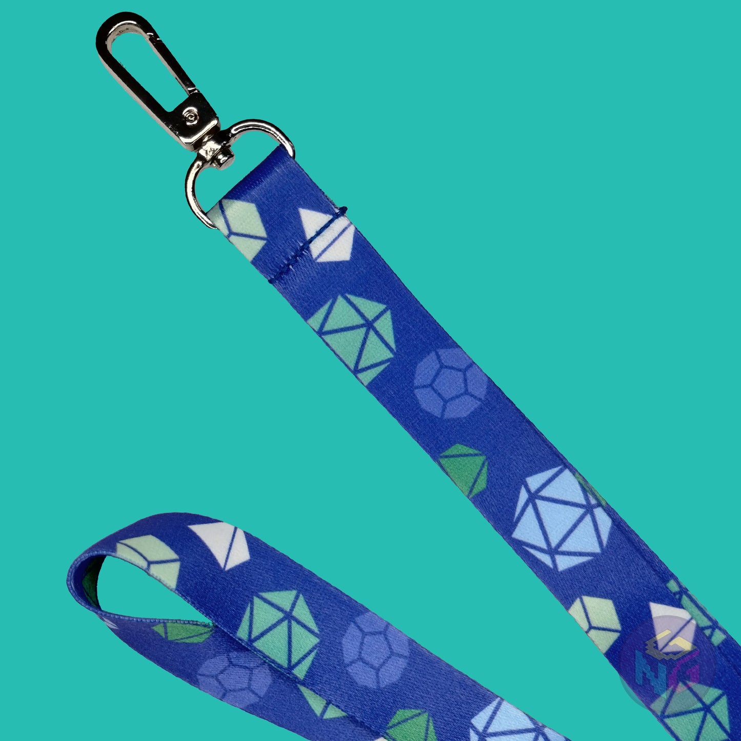 close up detail of the gay dungeons and dragons lanyard showing the lobster clasp, green d20s, blue d12s, white d4s, and other dice