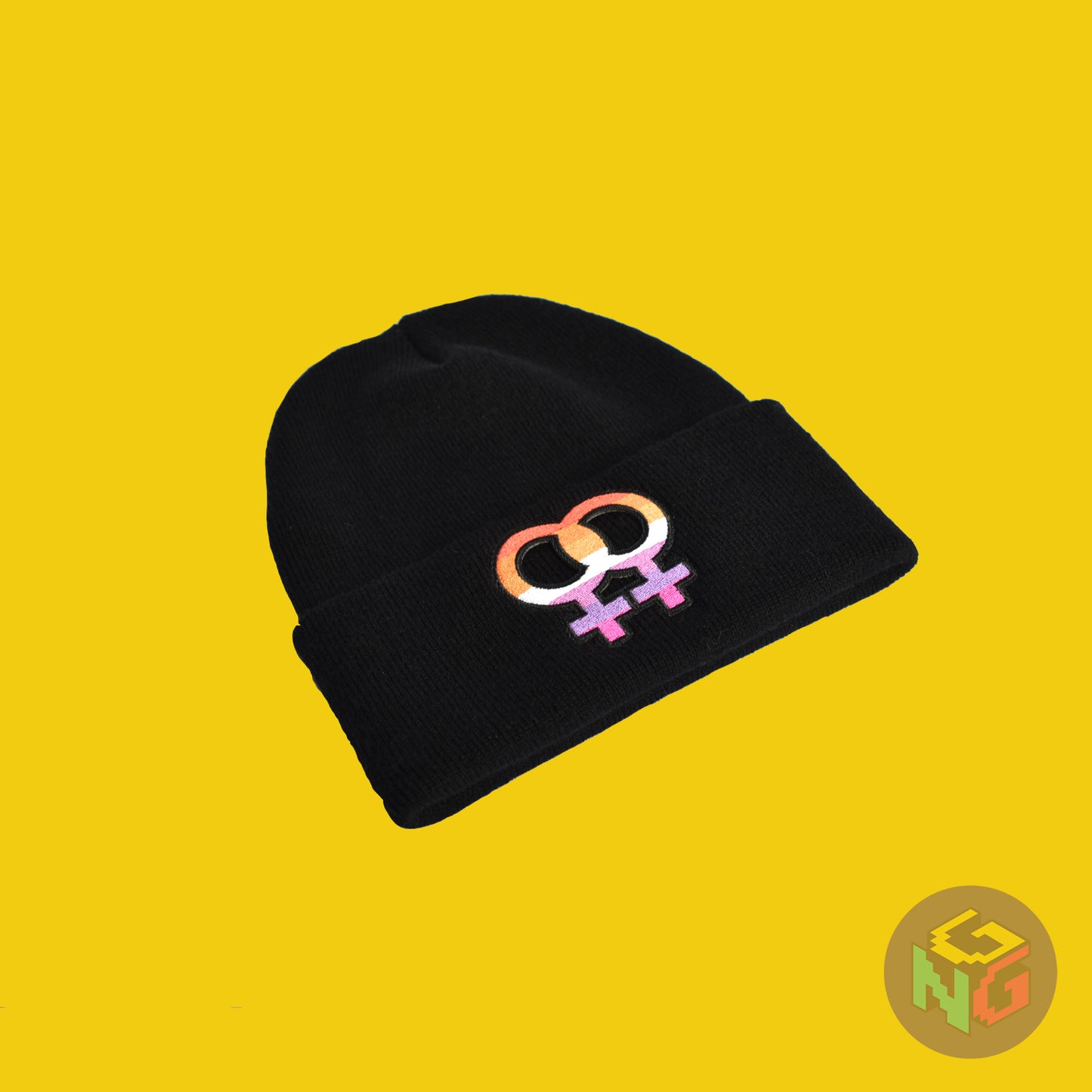 black lesbian pride beanie lying flat at an angle in front of yellow background