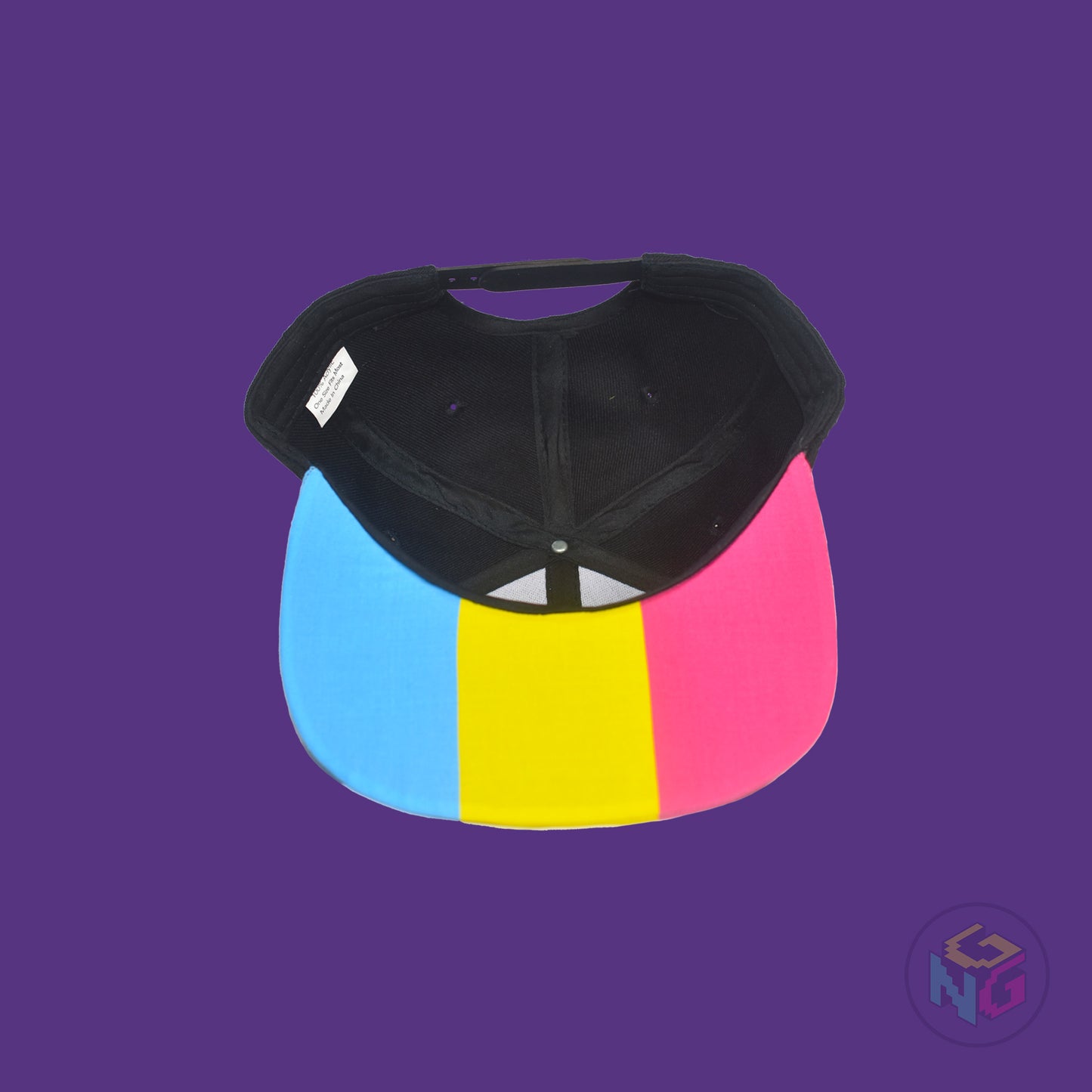Black flat bill snapback hat. The brim has the pansexual pride flag on both sides and the front of the hat has the word “PAN” in pink, yellow, and blue letters. Underside view