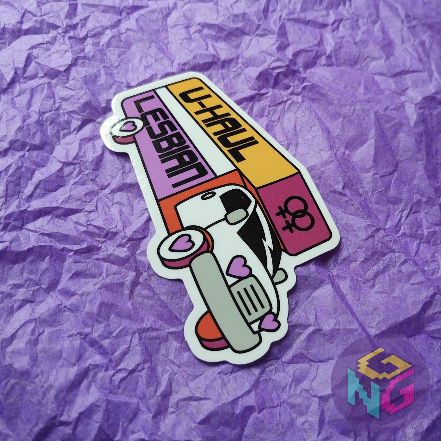 uhaul lesbian sticker at an angle flat on purple background