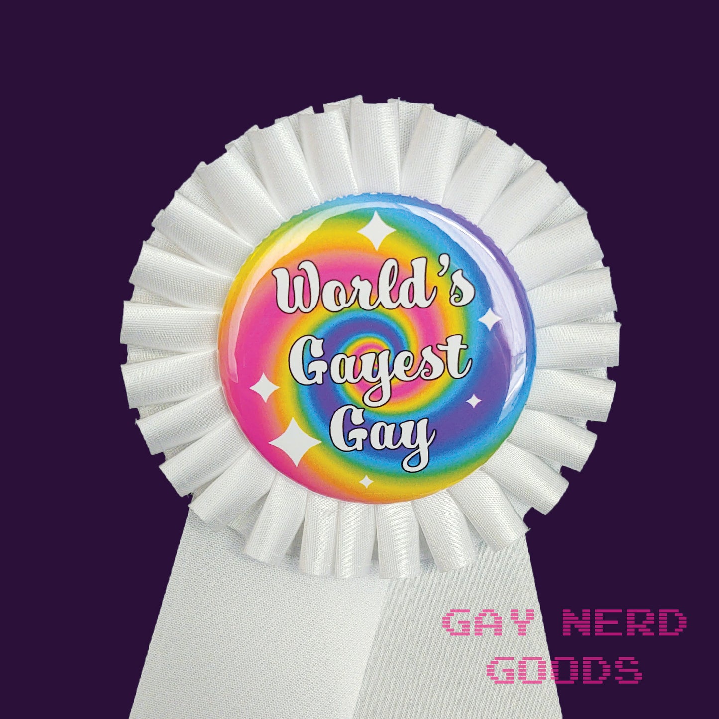 close up of the button in the ribbon. It's rainbow swirl with white text that ways "world's gayest gay" surrounded by white sparkles