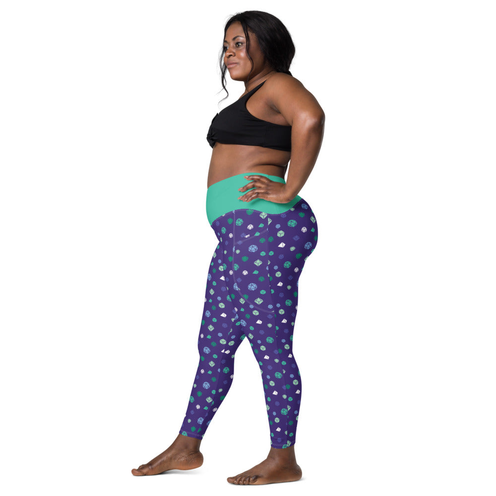Left side view of dark-skinned female-presenting model wearing the gay mlm dice leggings and black sports bra. She is facing left with her left hand on her hip and right leg forward