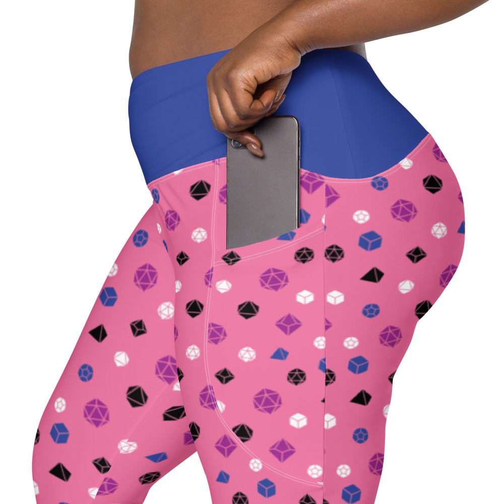 left side view of the genderfluid dnd dice plus size leggings. the dark-skinned female-presenting model is sliding her phone into one of the side pockets