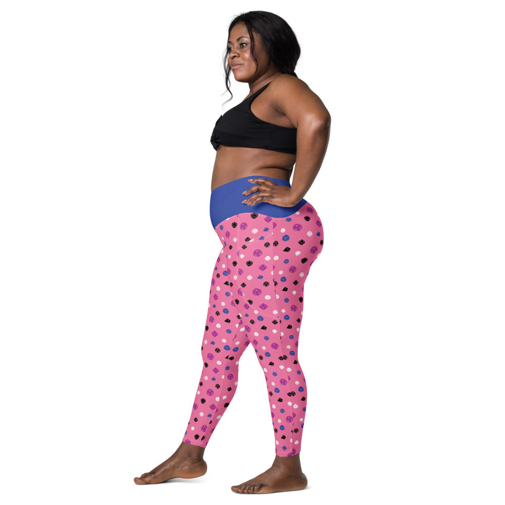 Left side view of dark-skinned female-presenting model wearing the genderfluid dice leggings and black sports bra. She is facing left with her left hand on her hip and right leg forward