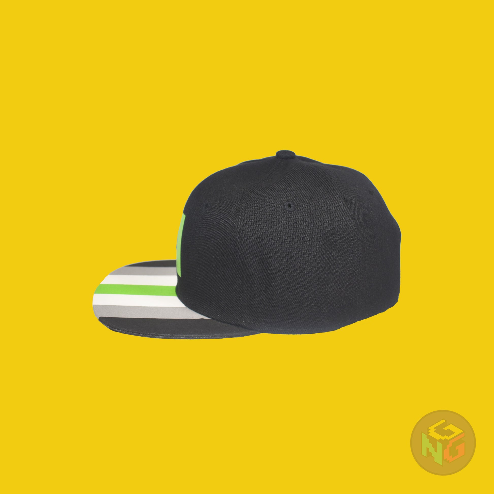 Black flat bill snapback hat. The brim has the agender pride flag on both sides and the front of the hat has a green letter “A”. Left side view