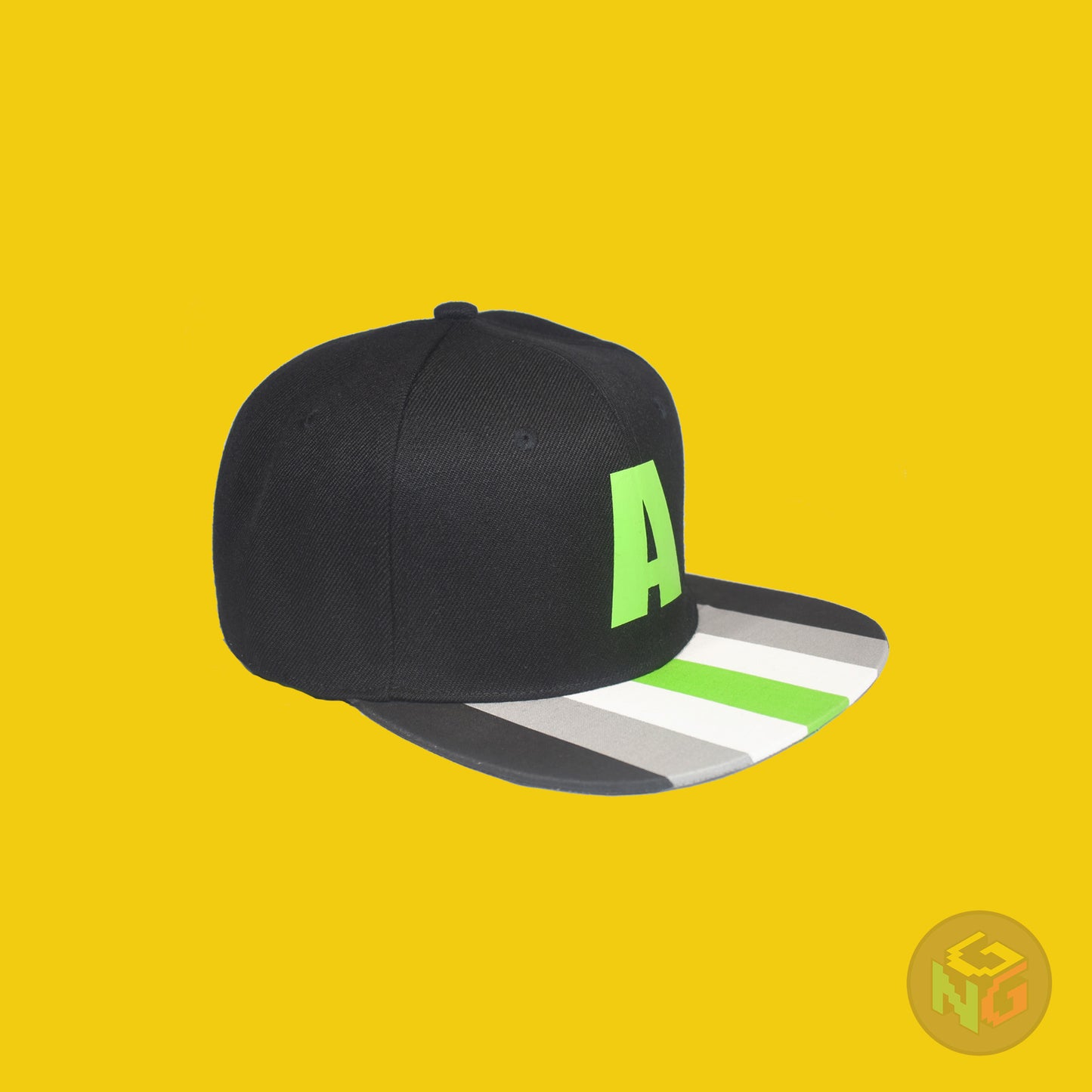 Black flat bill snapback hat. The brim has the agender pride flag on both sides and the front of the hat has a green letter “A”. Front right view
