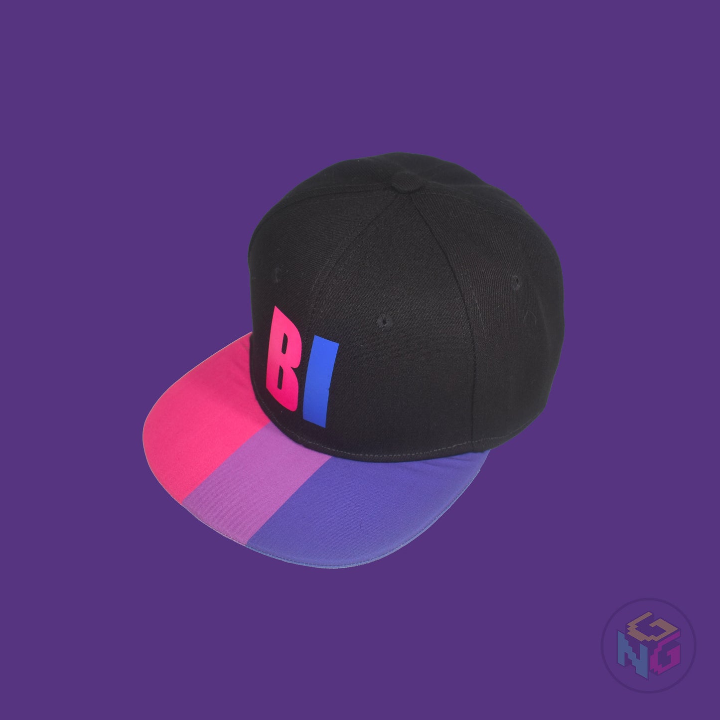 Black flat bill snapback hat. The brim has the bisexual pride flag on both sides and the front of the hat has the word “BI” in pink and blue. Front left view