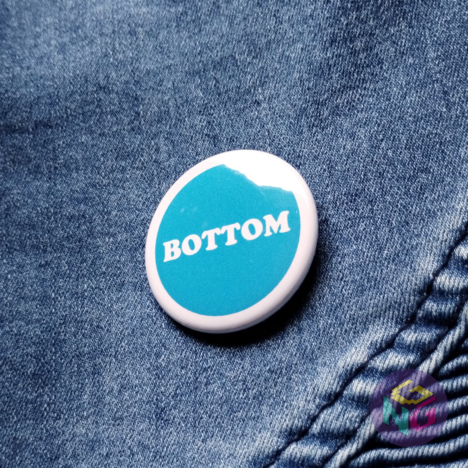 round bottom pin in front of denim background