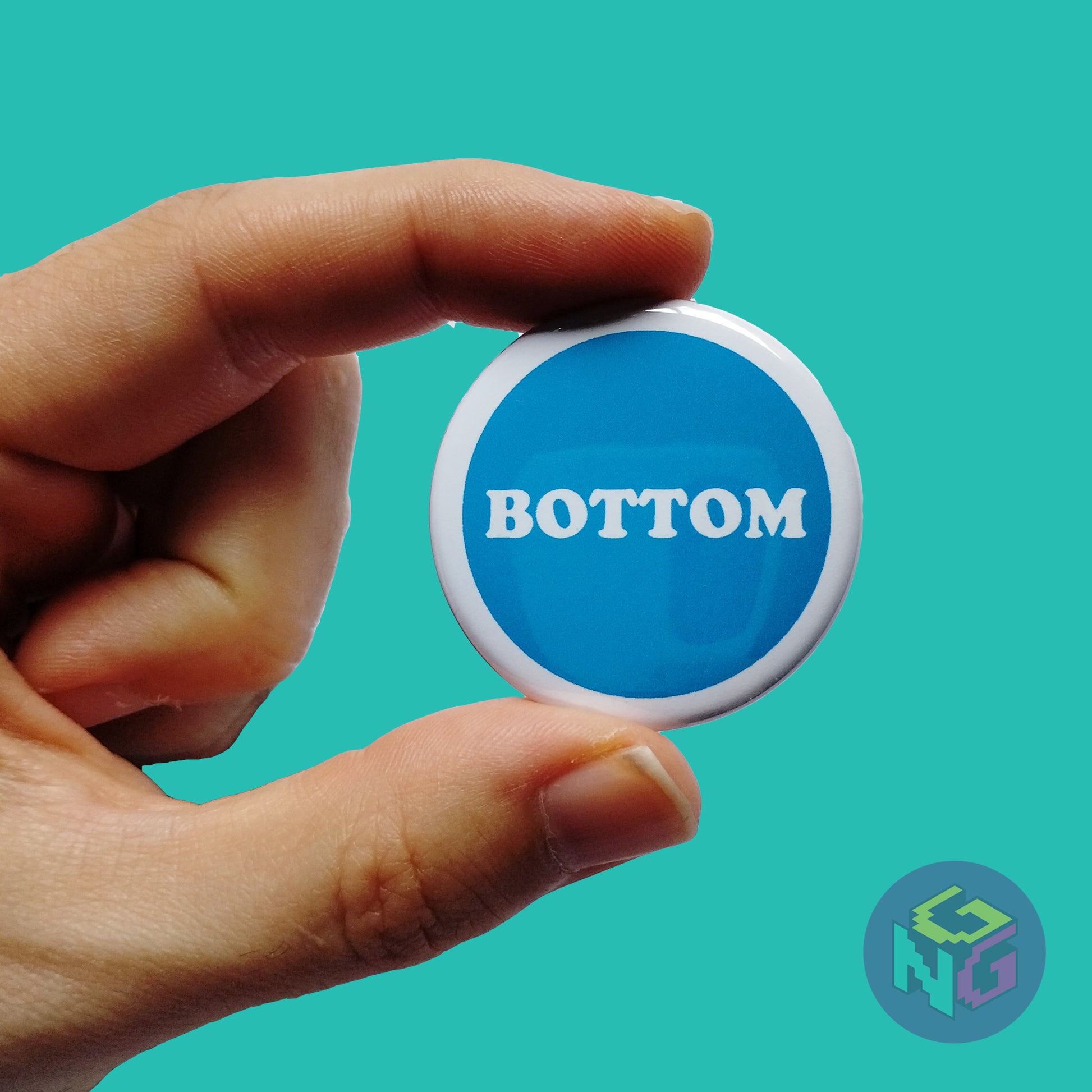 blue bottom button held in hand in front of mint green background