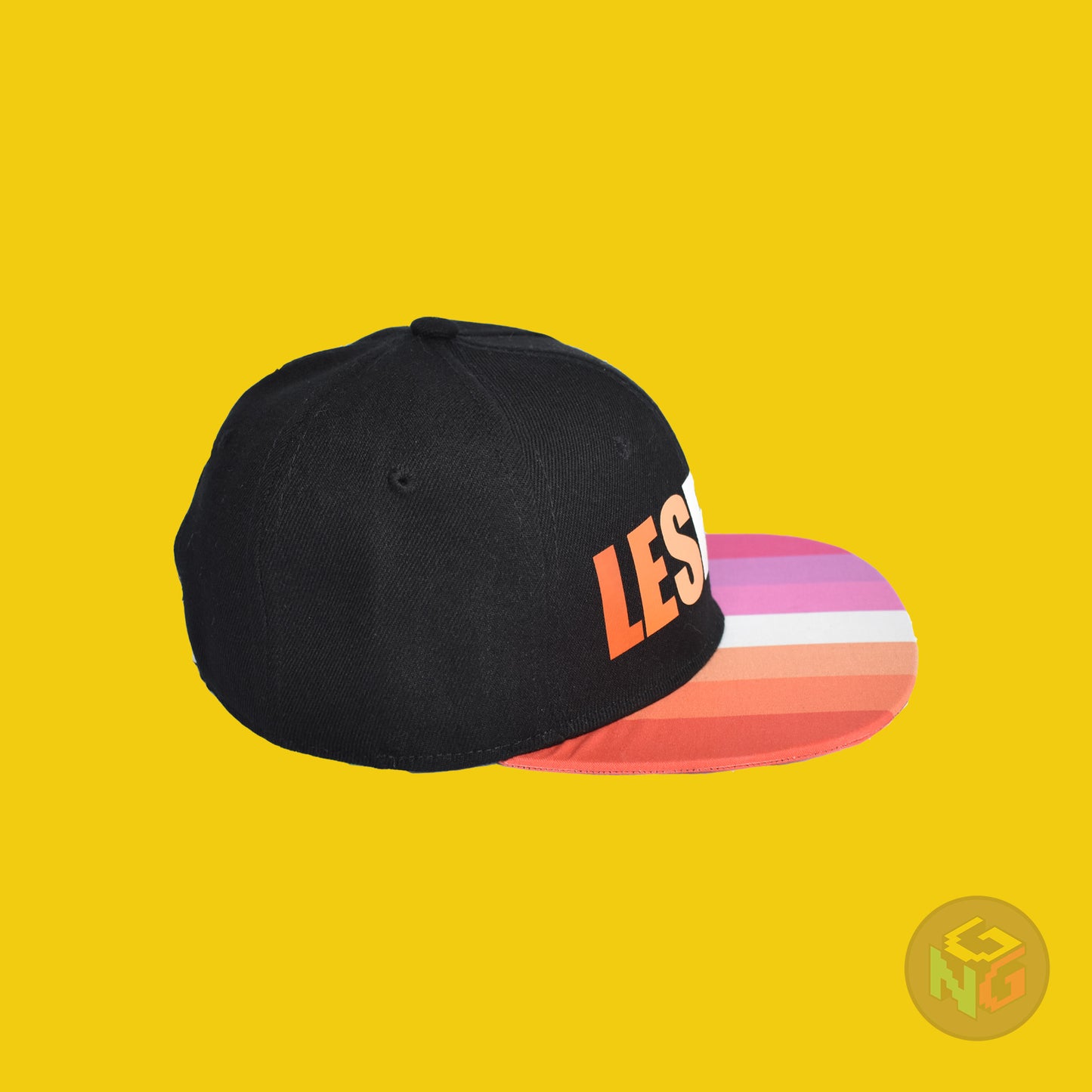 Black flat bill snapback hat. The brim has the lesbian pride flag on both sides and the front of the hat has the word “LESBIAN” in orange, pink, and white letters. Right view