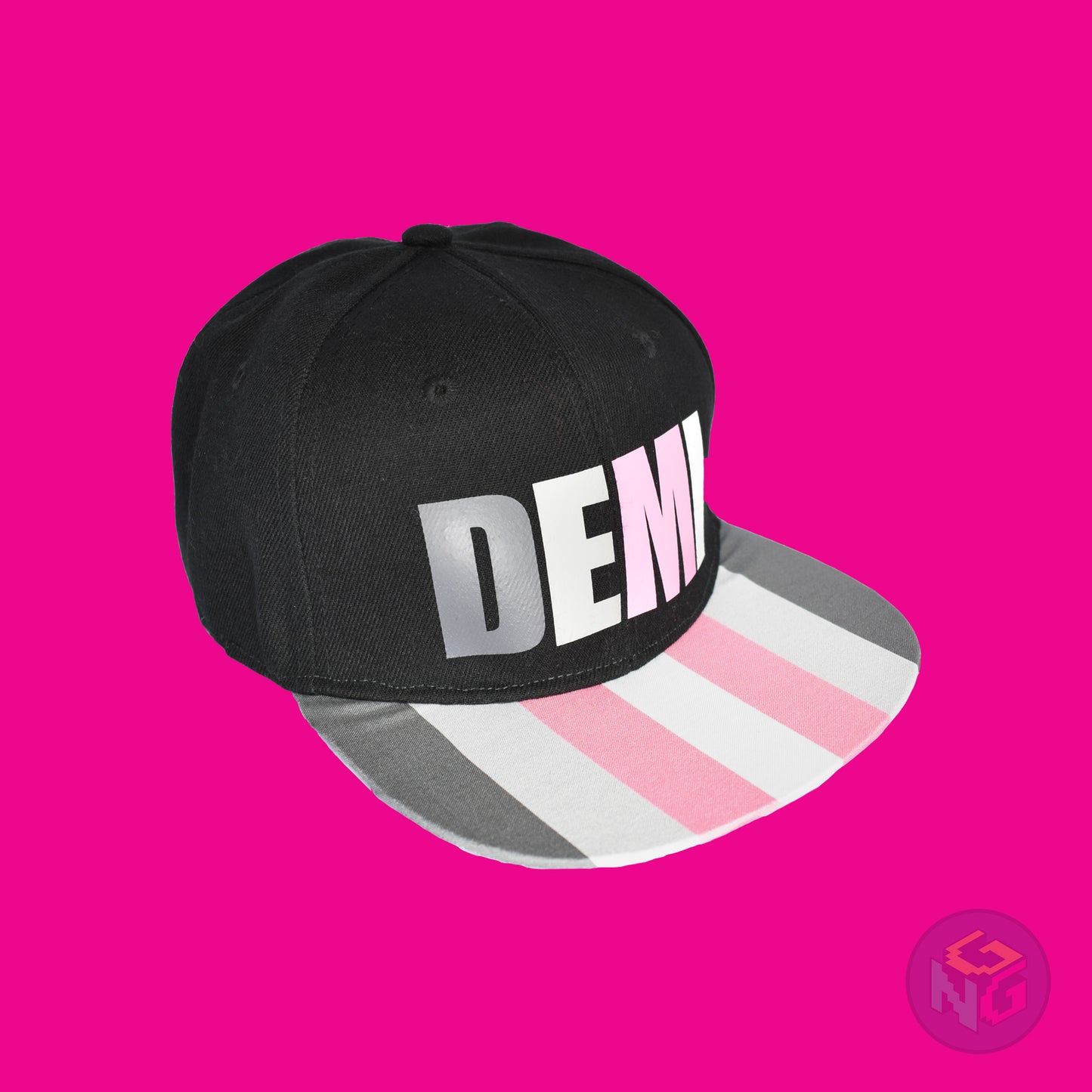 Black flat bill snapback hat. The brim has the demigirl pride flag on both sides and the front of the hat has the word “DEMI” in dark grey, light grey, pink, and white. Front right view