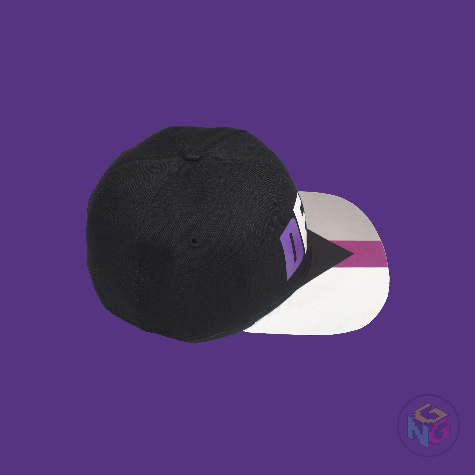 Black flat bill snapback hat. The brim has the demisexual pride flag on both sides and the front of the hat has the word “DEMI” in purple, white, and grey. Top right view