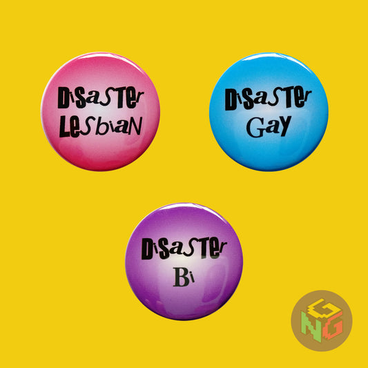 pink disaster lesbian pin, blue disaster gay button, purple disaster bi pin on yellow background