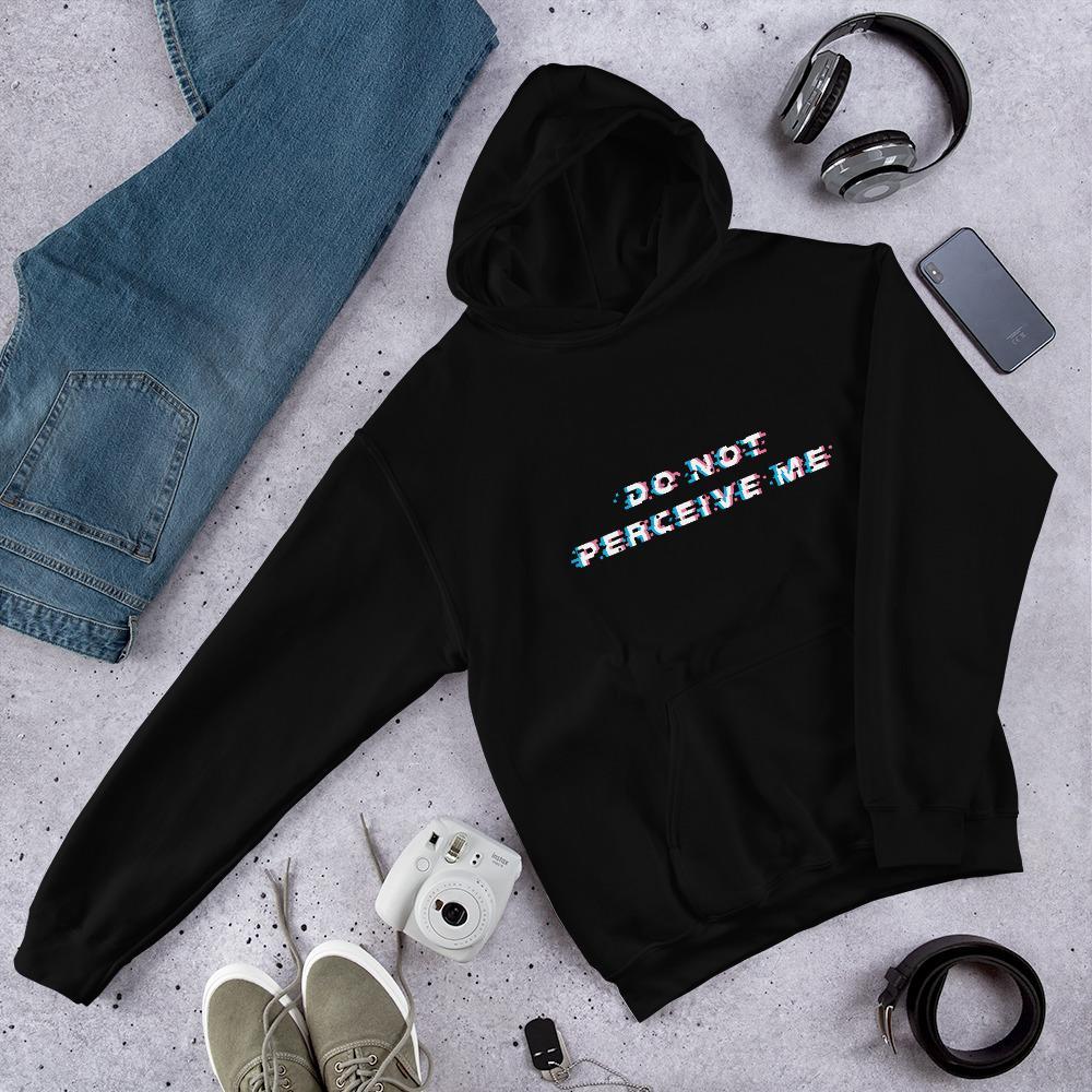 do not perceive me black hoodie lying flat on concrete with jeans, headphones, shoes, and camera