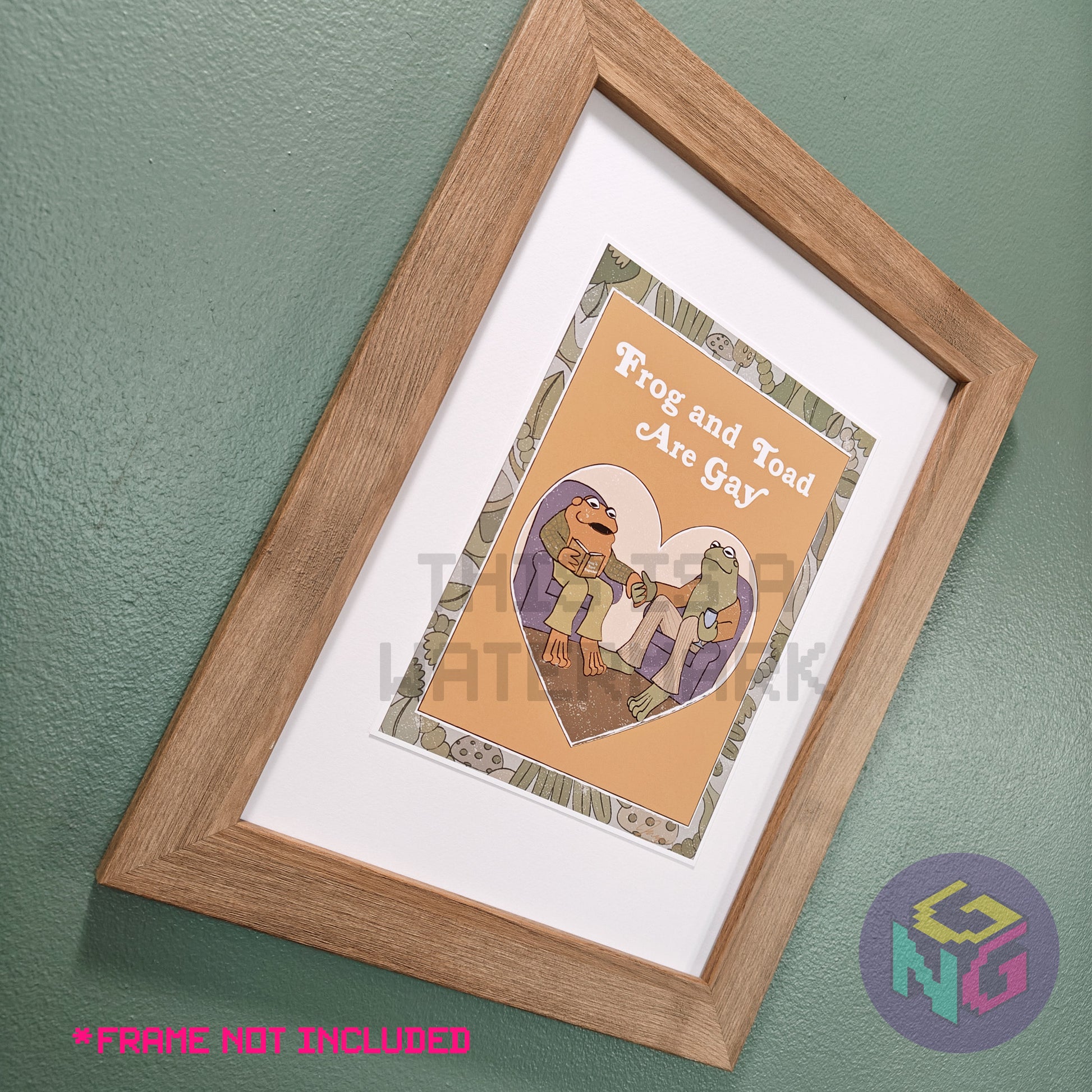 art print of imagined frog and toad book cover showing frog and toad holding hands and the title "frog and toad are gay" in wood frame