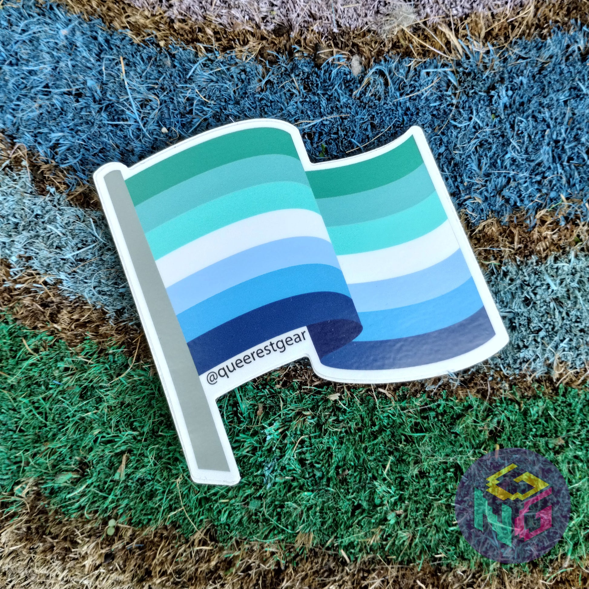 gay mlm flag sticker lying flat on rainbow welcome mat