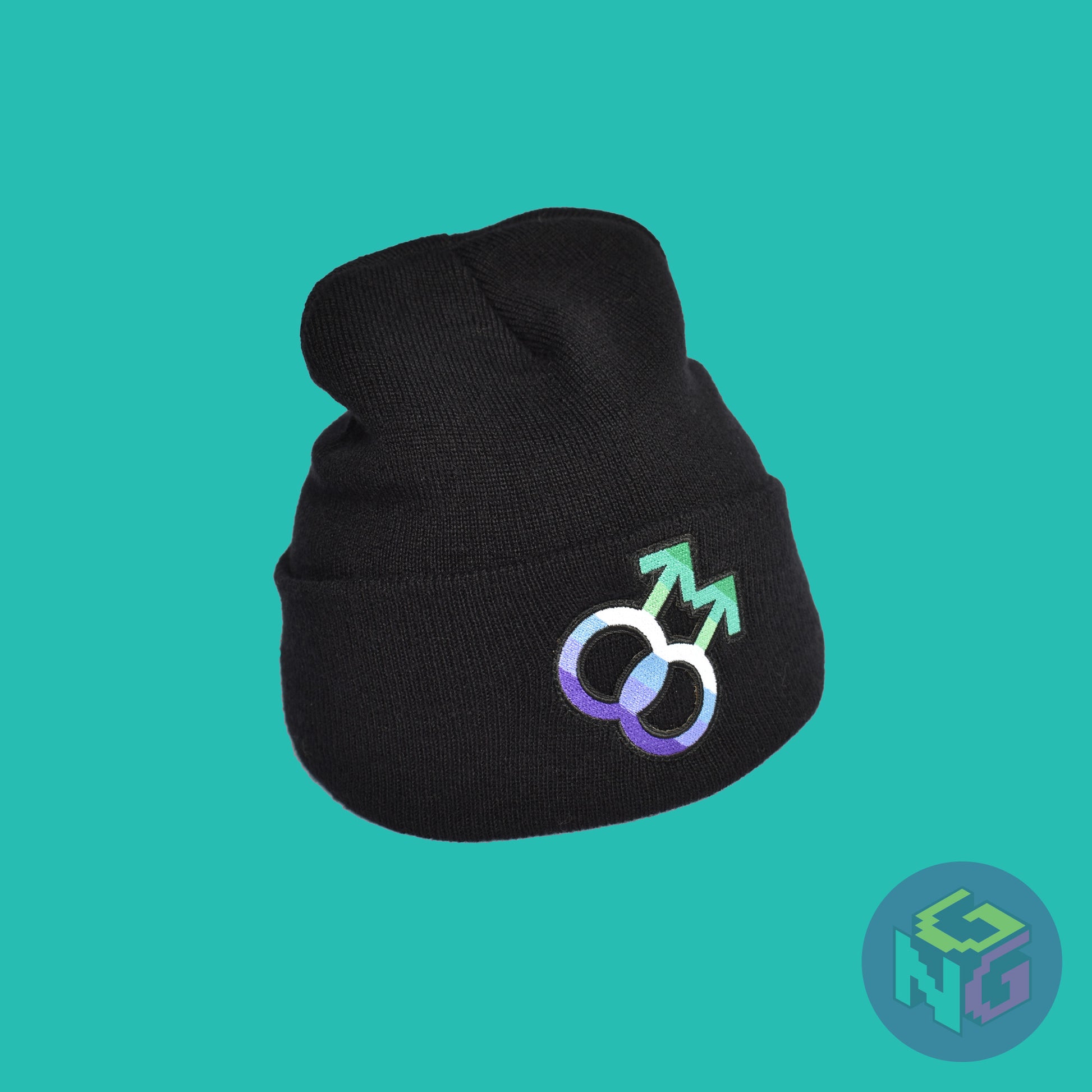 Black knit fabric beanie with the gay symbol in greens, blues, and white on the front. It is stretched and sitting upright in a right front view