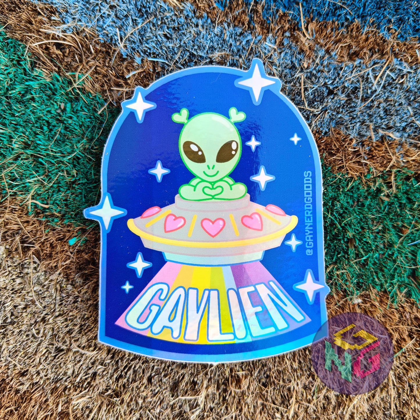 gaylien holographic alien sticker with a littel green alien in a spaceship with a rainbow beam