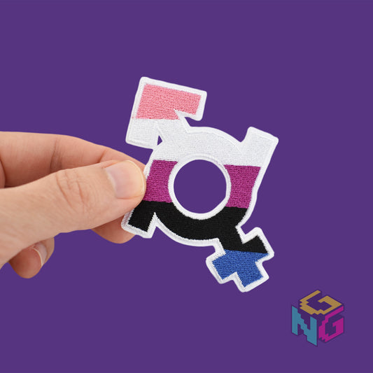 genderfluid iron on patch held in front of purple background