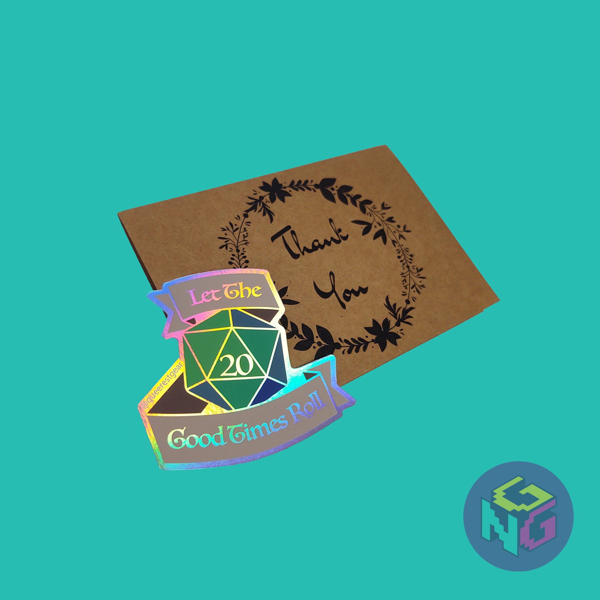 rainbow holographic d20 let the good times roll d20 in front of brown kraft paper thank you card on mint green background