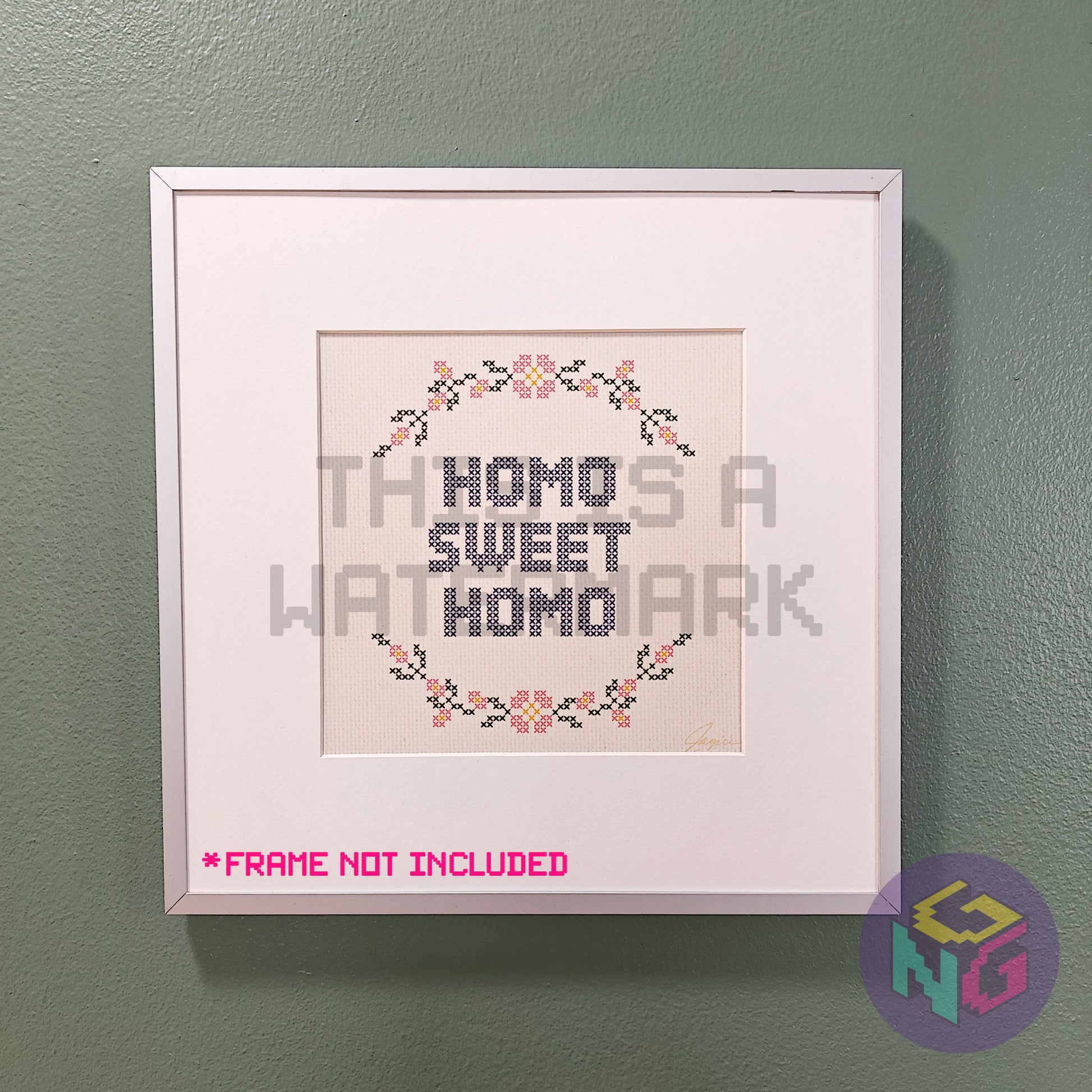 art print in an embroidery style showing a circle of flowers and the text "homo sweet homo" in a silver frame