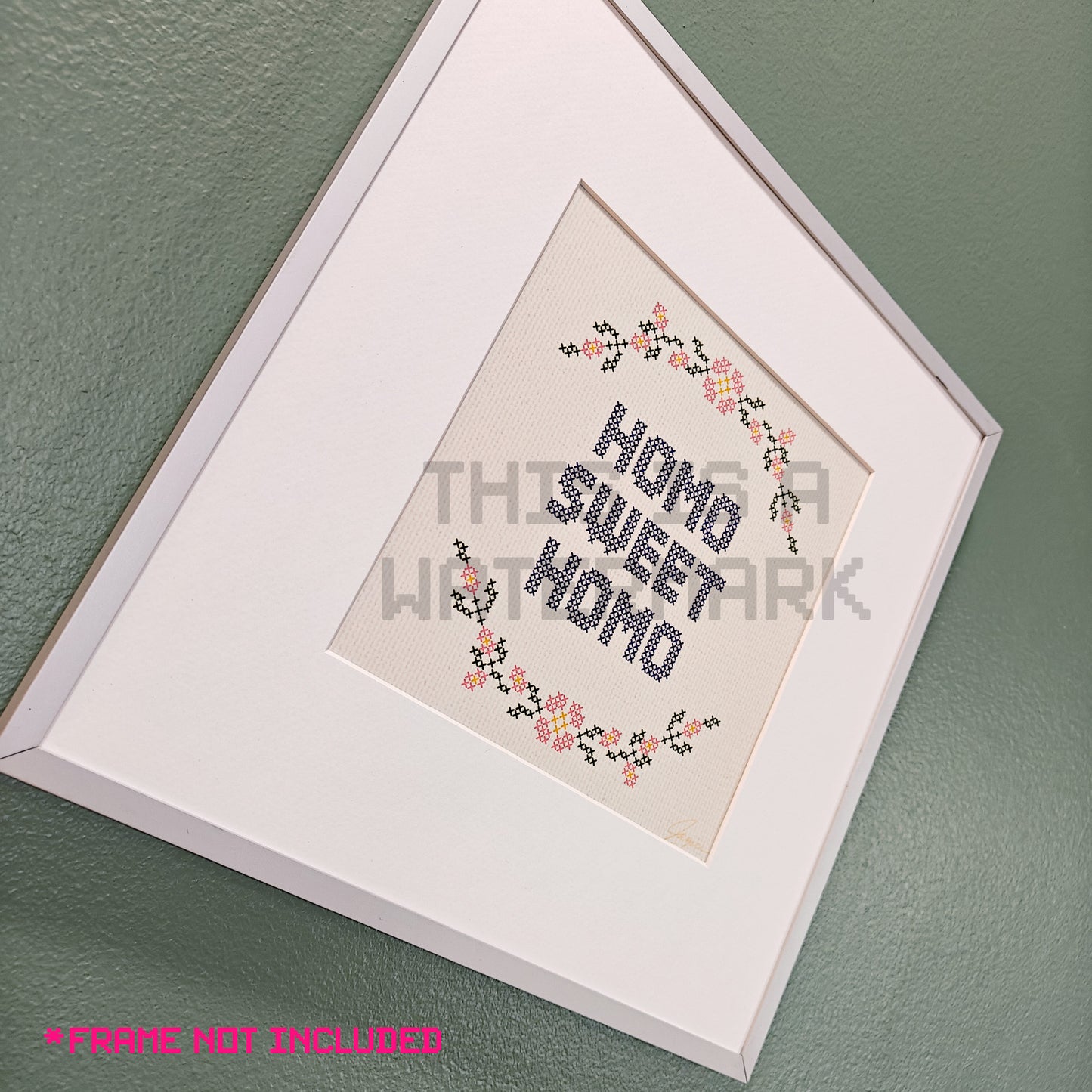 art print in an embroidery style showing a circle of flowers and the text "homo sweet homo" in a silver frame