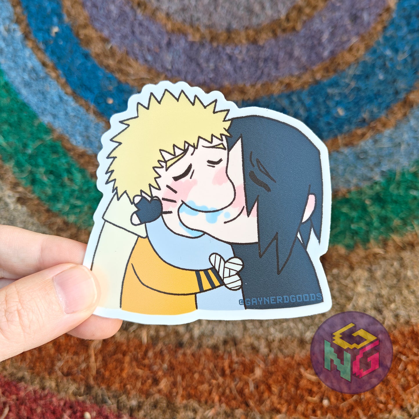 sasuke and naruto sasunaru making out vinyl sticker kiss meme being held in front of a rainbow