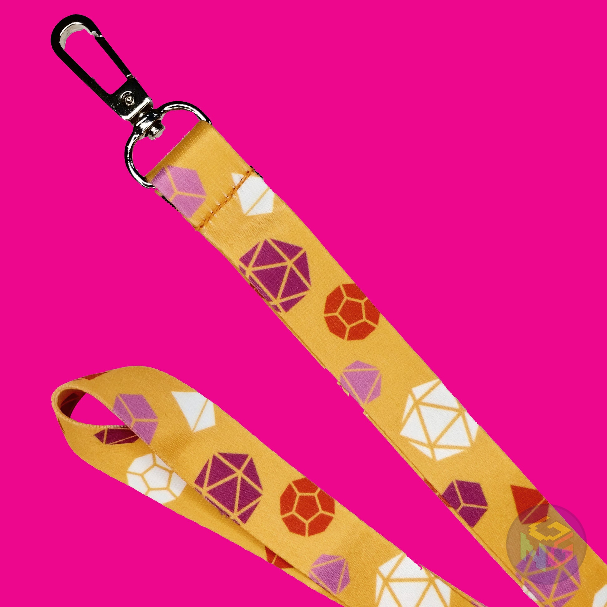 close up detail of the lesbian dungeons and dragons lanyard showing the lobster clasp, pink d20s, orange d12s, white d4s, and other dice