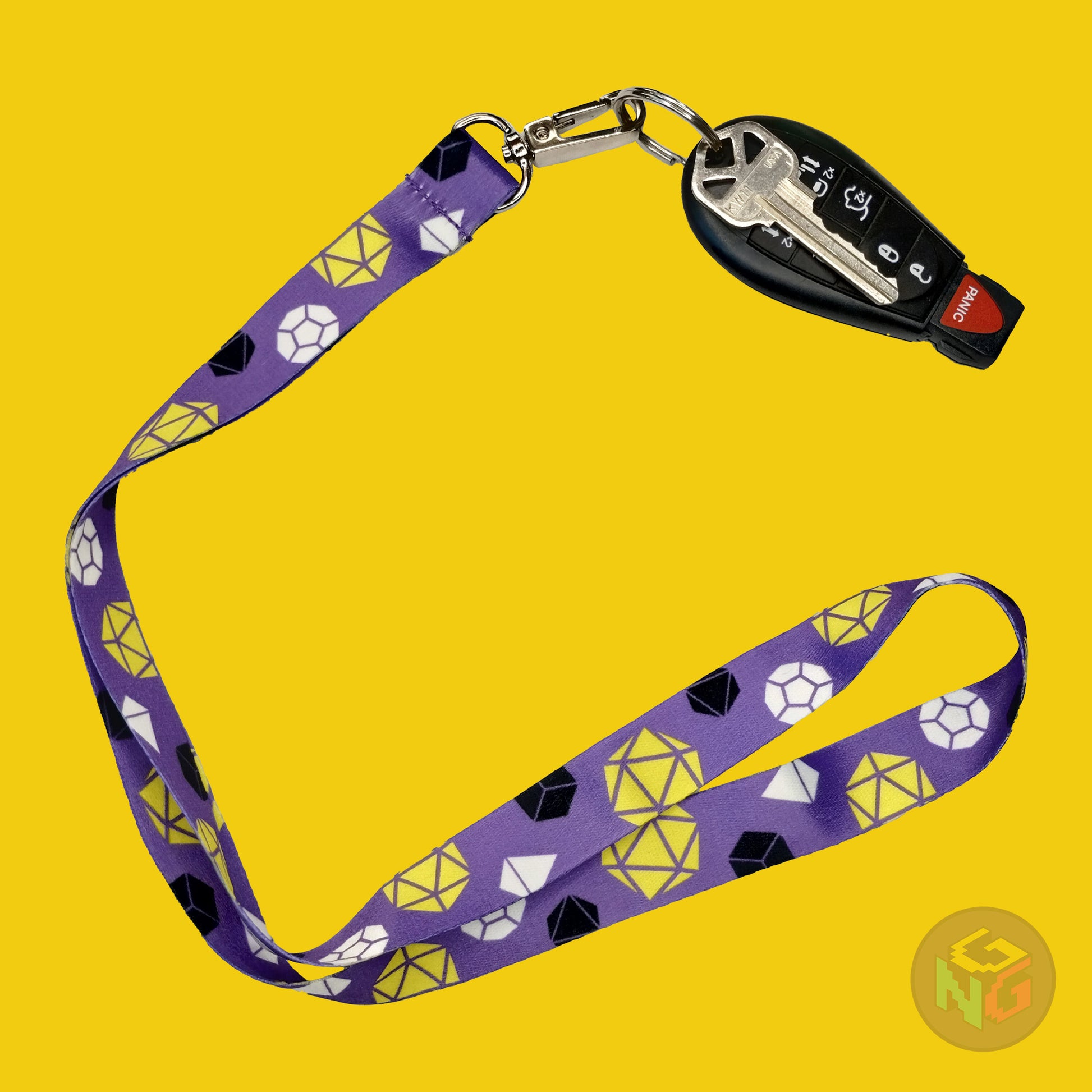 purple dnd nonbinary lanyard showing the black, white, and yellow tabletop dice with a key fob clipped to the end of the lanyard