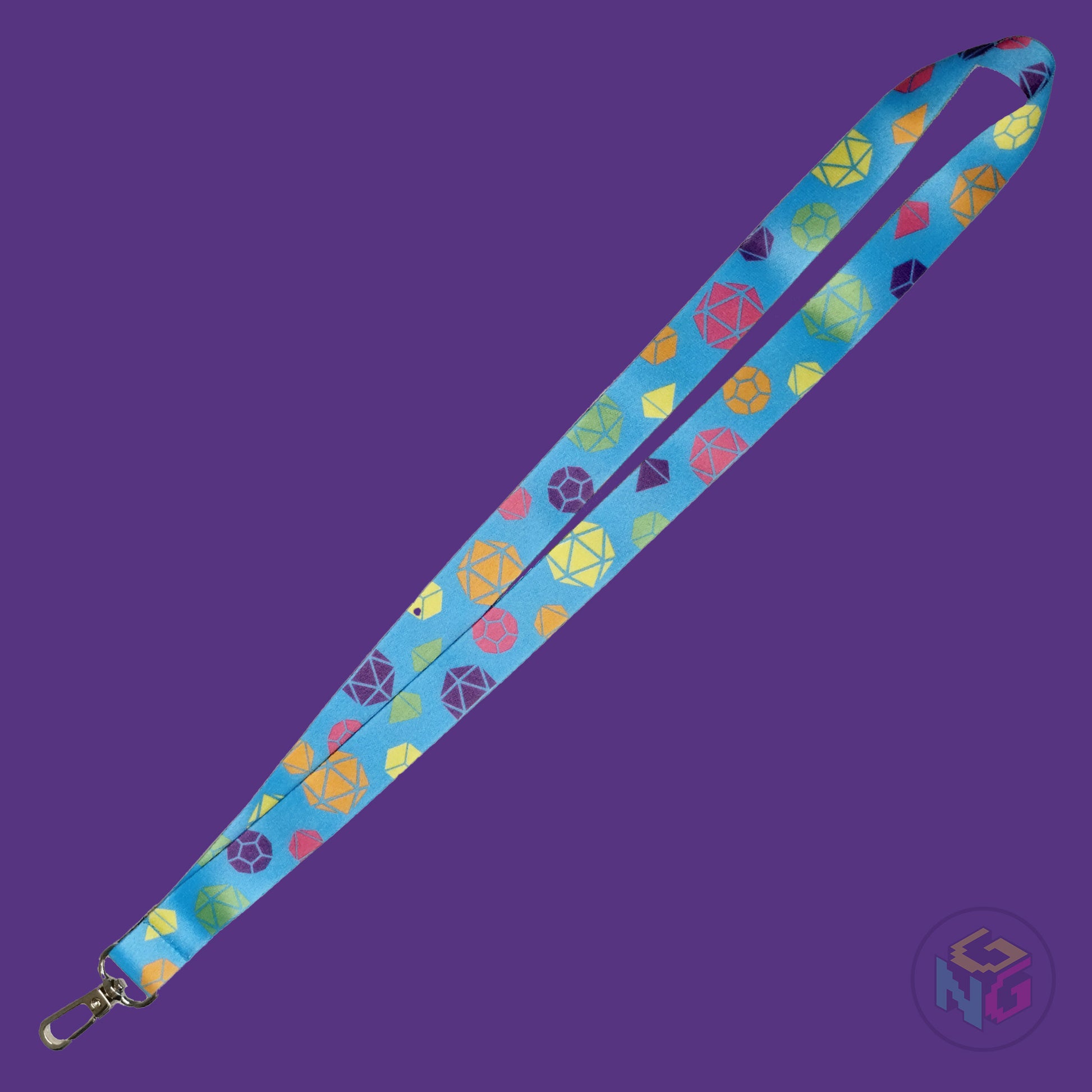 the rainbow pride dice lanyard lying flat showing the complete design and repeating pattern of polyhedral dice in rainbow colors