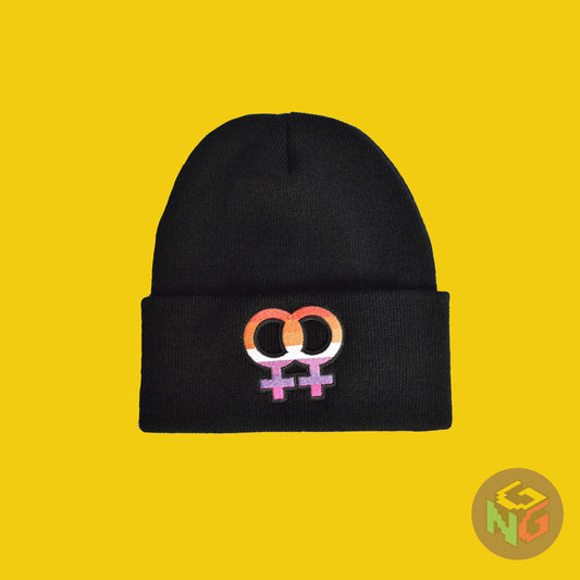 lesbian pride symbol beanie lying flat in front of yellow background