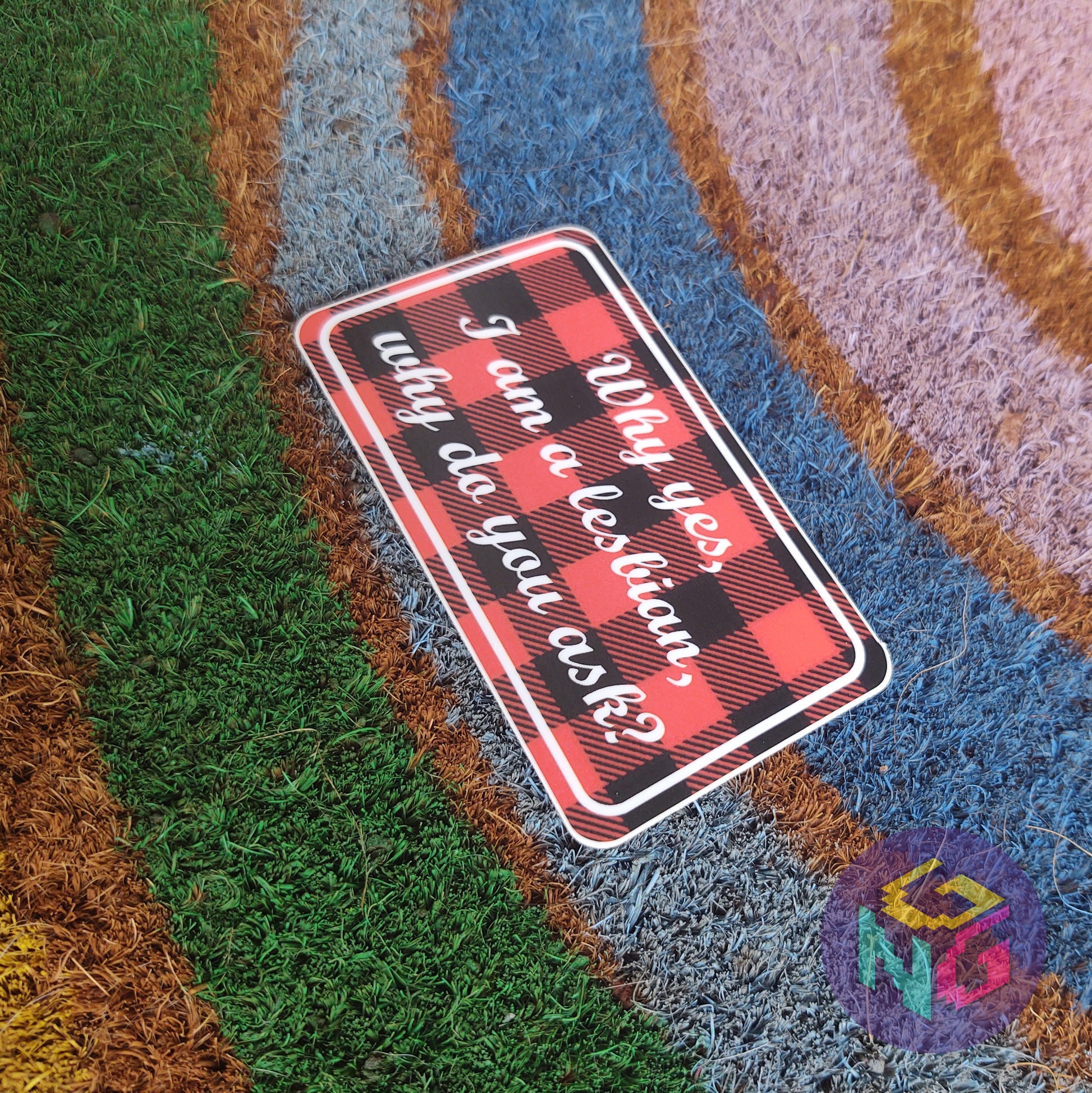 why yes i am a lesbian why do you ask lesbian pride sticker lying flat at an angle on rainbow welcome mat