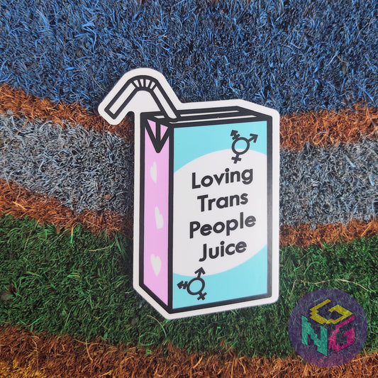 loving trans people juice vinyl sticker lying flat on rainbow welcome mat