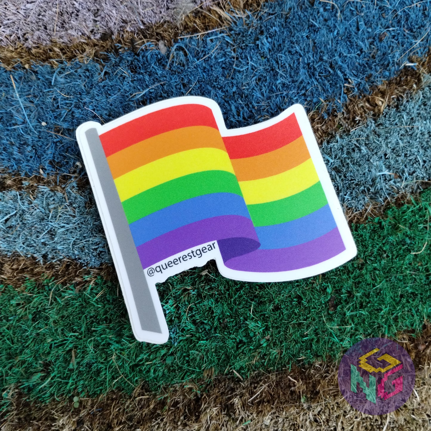 rainbow flag sticker lying on rainbow welcome mat