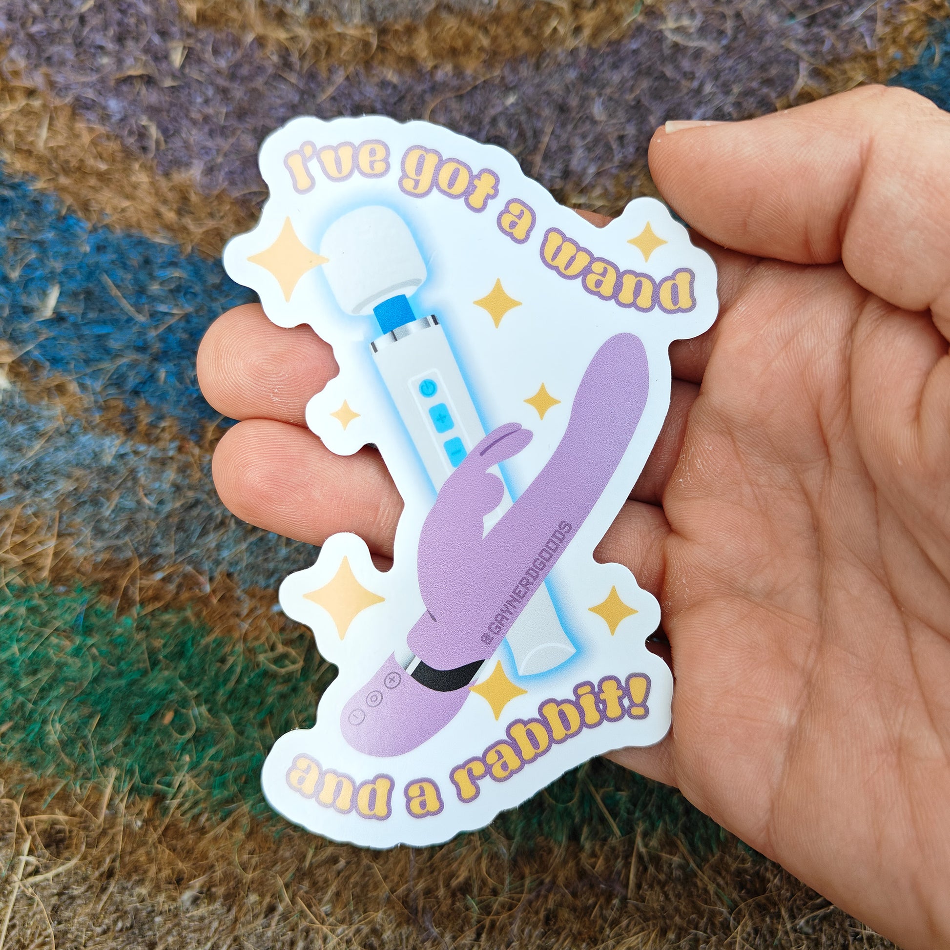 hand holding sex positive queer sticker with lyrics from red wine supernova