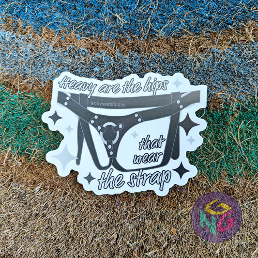 strap on harness vinyl sticker with text "heavy are the hips that wear the strap"