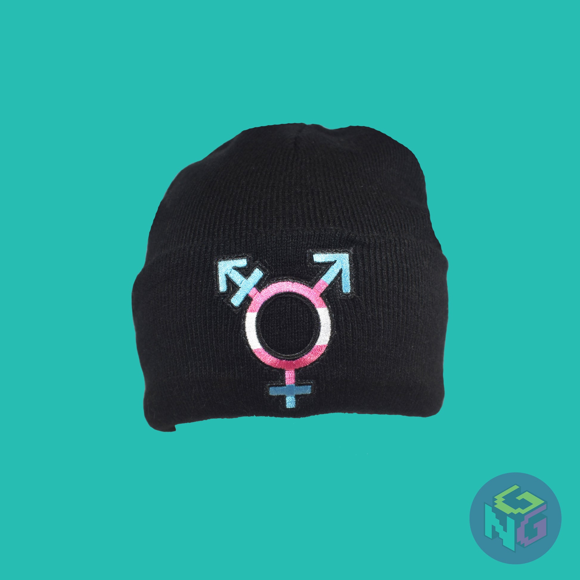 Black knit fabric beanie with the transgender symbol in blue, pink, and white on the front. It is stretched facing front on a mint green background
