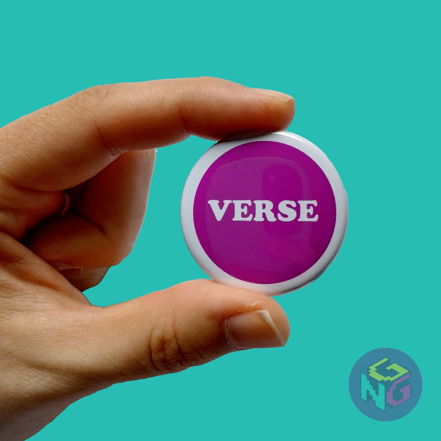 purple verse pin held in a hand in front of a mint green background
