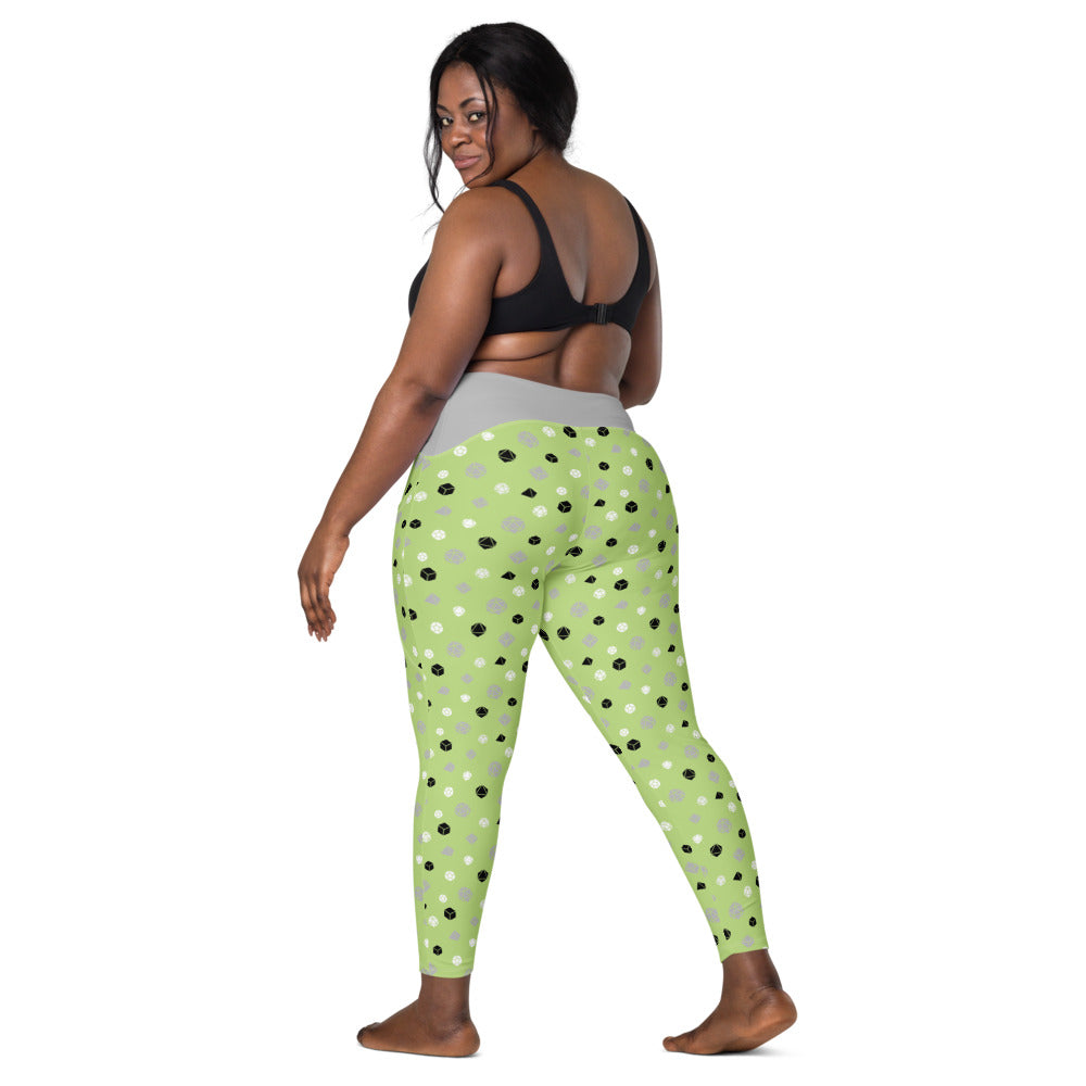 back view of dark-skinned female-presenting plus size model looking over her shoulder. She is wearing the agender dice leggings and a black sports bra