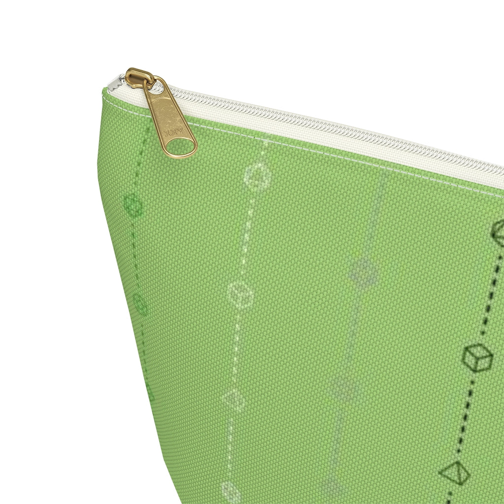 the large aromantic dice t-bottom pouch zoomed in on the corner on a white background. it's green with black, grey, white, and green stripes of dashed lines and polyhedral dice and a gold zipper pull