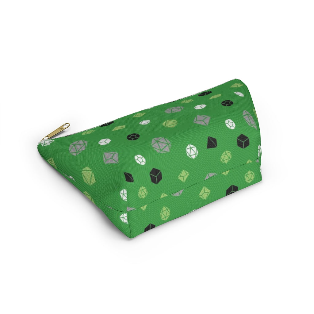 the small aromantic dice t-bottom pouch in bottom view on a white background. it's green with green, grey, black, and white polyhedral dice and a gold zipper pull
