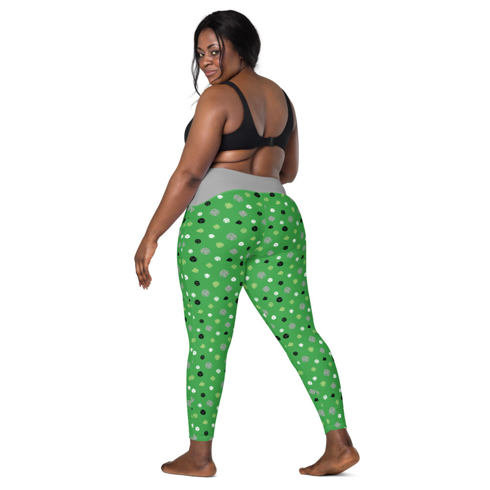 back view of dark-skinned female-presenting plus size model looking over her shoulder. She is wearing the aromantic dice leggings and a black sports bra