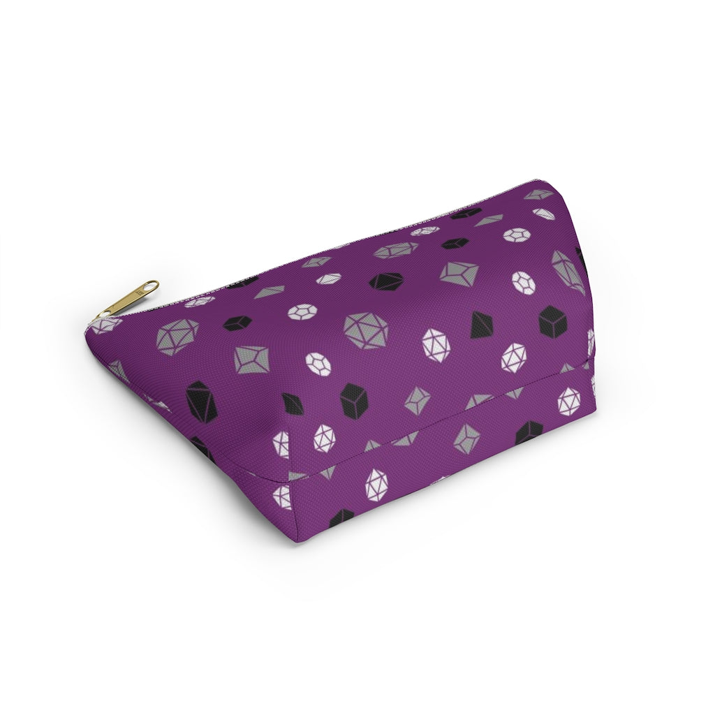 the small asexual dice t-bottom pouch in bottom view on a white background. it's purple with grey, black, and white polyhedral dice and a gold zipper pull